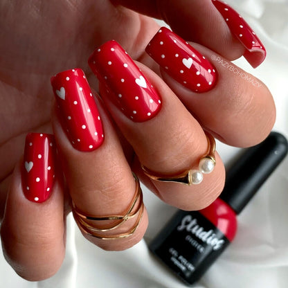 Studios Didier Lab Impulse red manicure with white hearts and dots