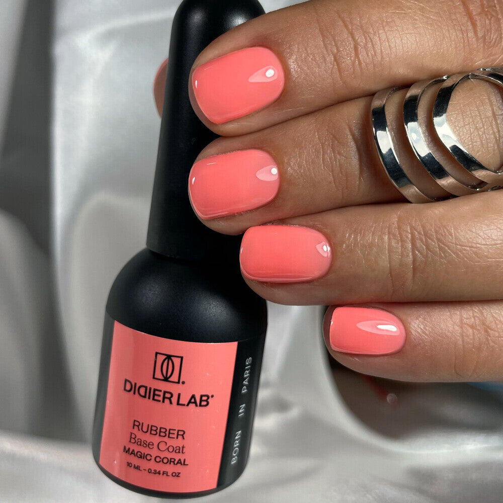 Didier Lab Rubber Base Coat Magic Coral 10ml bottle with glossy coral manicure